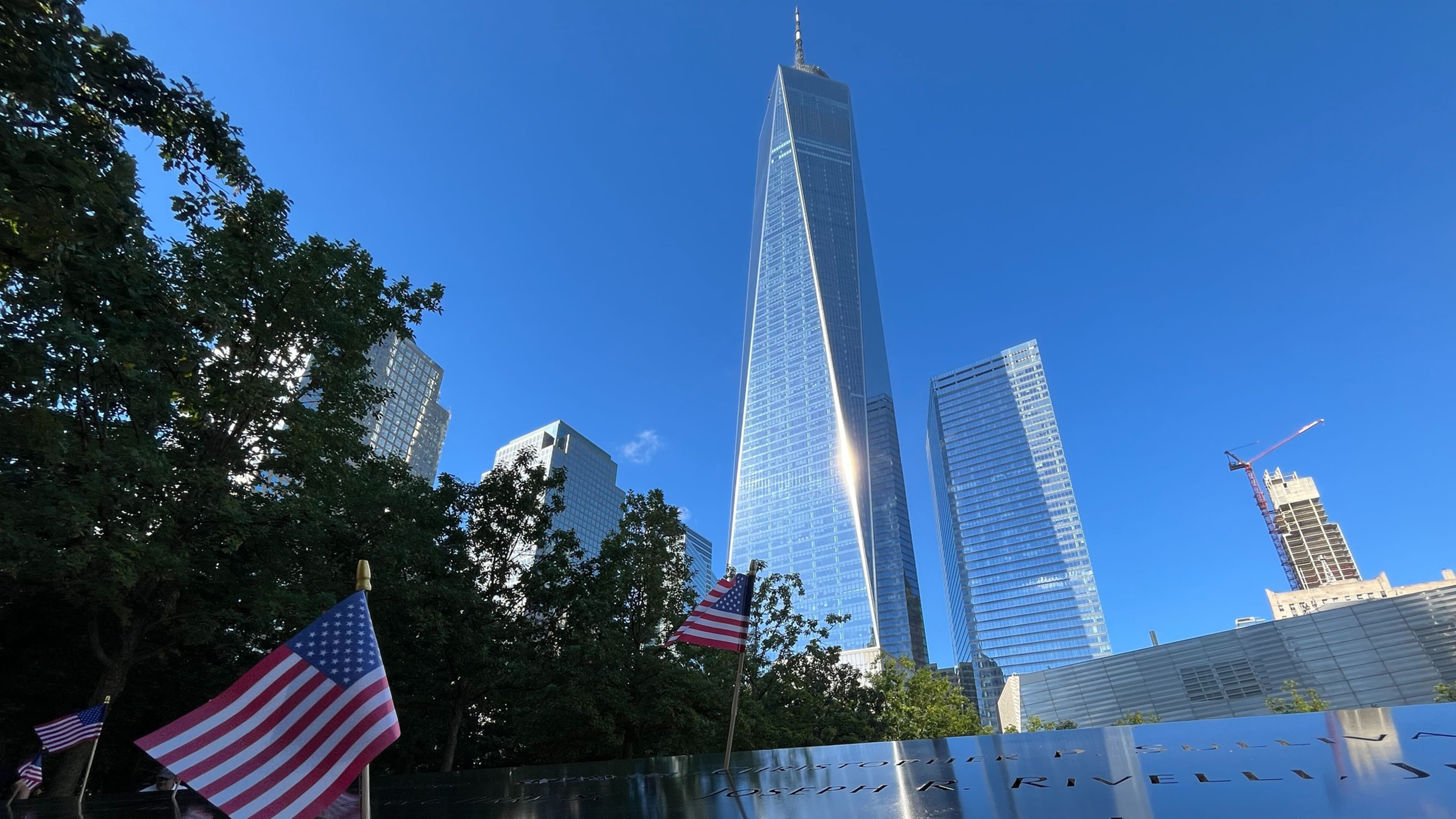 Flags are placed by the names of those killed during the Sept. 11, 2001, attacks at the reflecting pools at the National September 11 Memorial & Museum, Tuesday, Sept. 10, 2024, in New York.