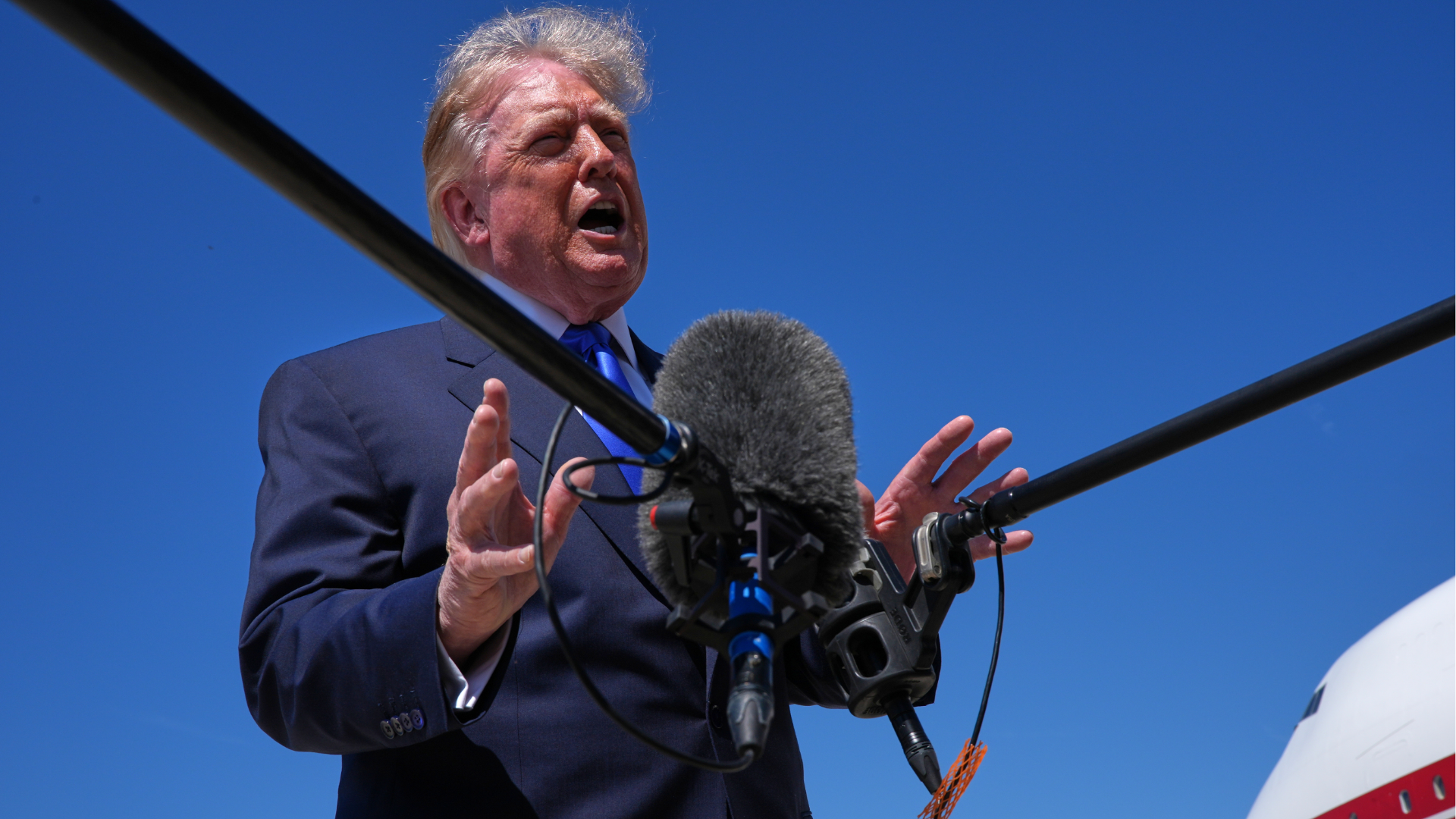 President Donald Trump talks with reporters after an emergency inflatable slide deployed on Air Force One before before Trump arrived to board at Joint Base Andrews, Md., Wednesday, Sept. 9, 2026. 