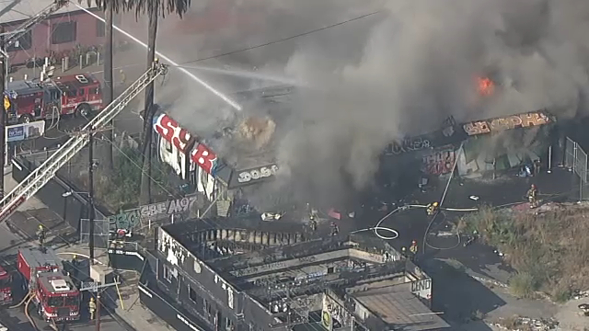 Firefighters battle commercial building fire in downtown Los Angeles as ...