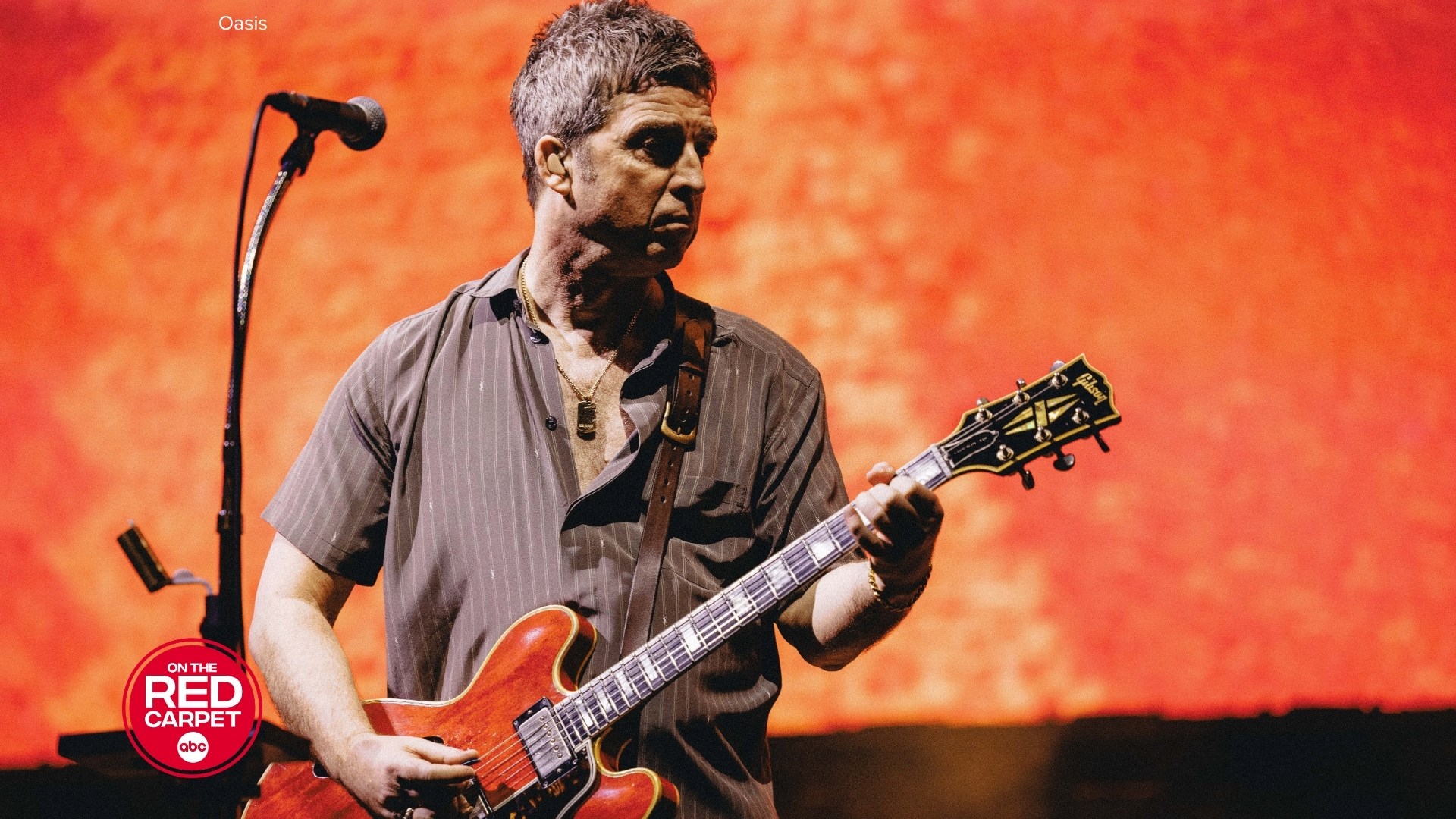 Noel Gallagher from Oasis playing the guitar.