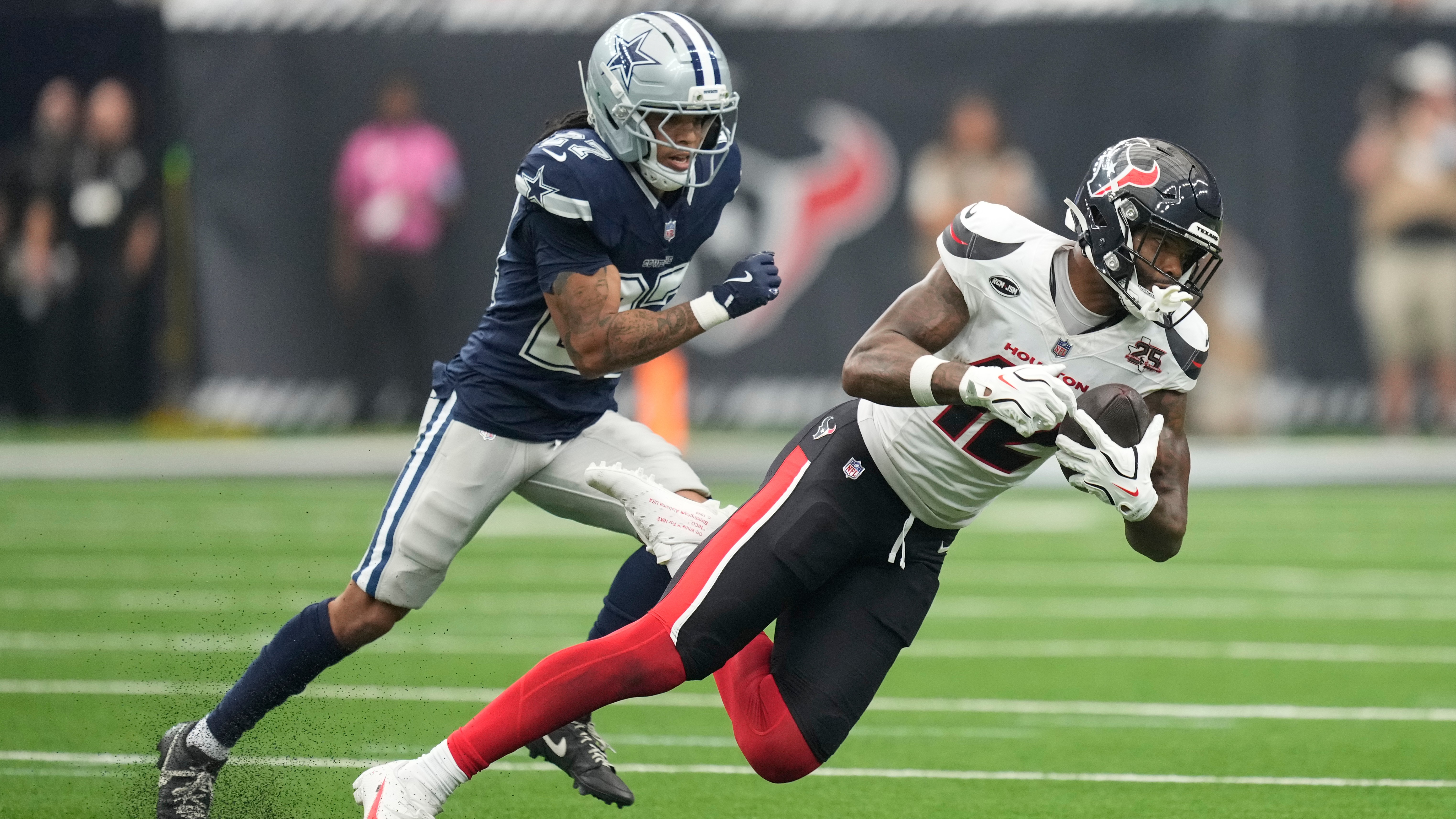 Texans receiver Nico Collins makes a catch as Cowboys cornerback Reddy Steward defends during the second half of an NFL football game in Houston, Sunday, Oct. 4, 2026.