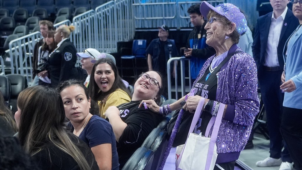 Golden State Valkyries fan Cynthia Cheak, right, hands out wristbands to fans before an WNBA basketball game between the Valkyries and Seattle Storm in San Francisco, Sept. 19, 2026.