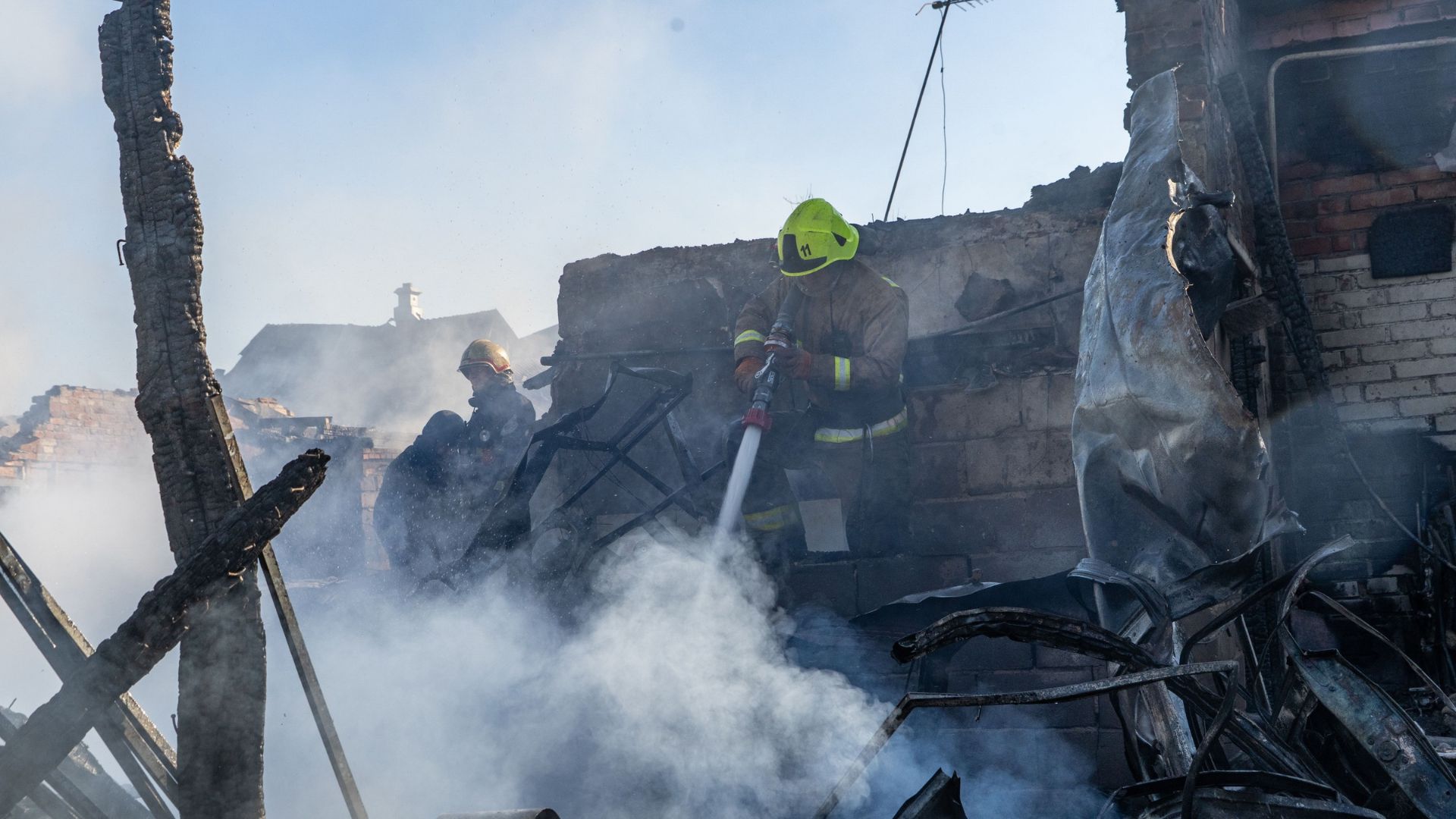 Rescue workers put out a fire of residential houses destroyed in a Russian strike on Kharkiv, Ukraine, Sunday, Oct. 11, 2026.