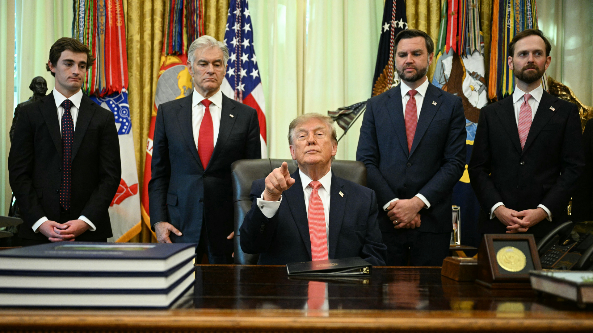 President Donald Trump makes an announcement on fraud with US Vice President JD Vance (2R) in the Oval Office of the White House in Washington, DC, on October 20, 2026.