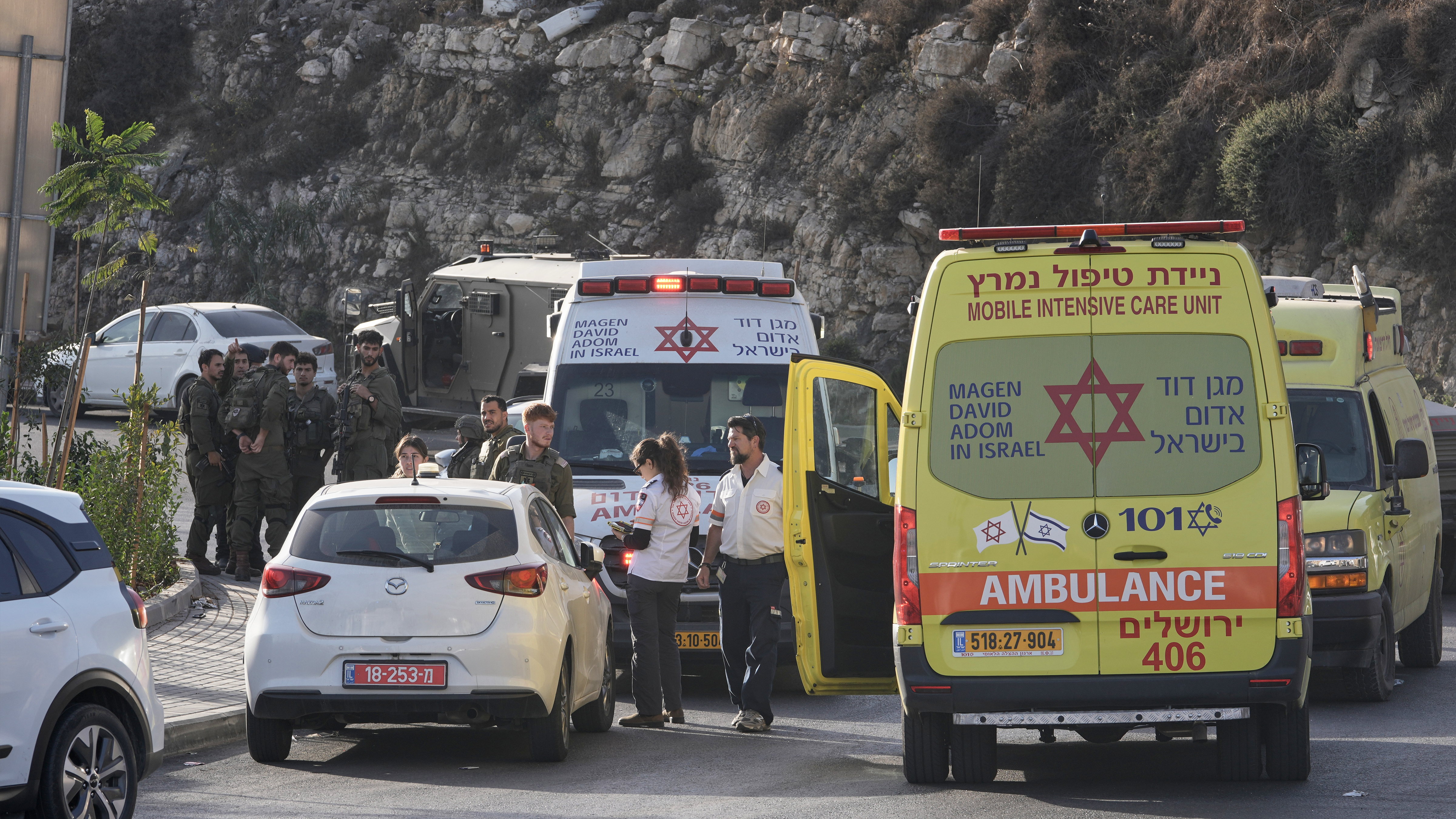 Israeli soldiers and emergency personnel gather near ambulances following a shooting attack near Yehuda Junction, near Hebron, in the occupied West Bank, Friday, Oct. 23, 2026.