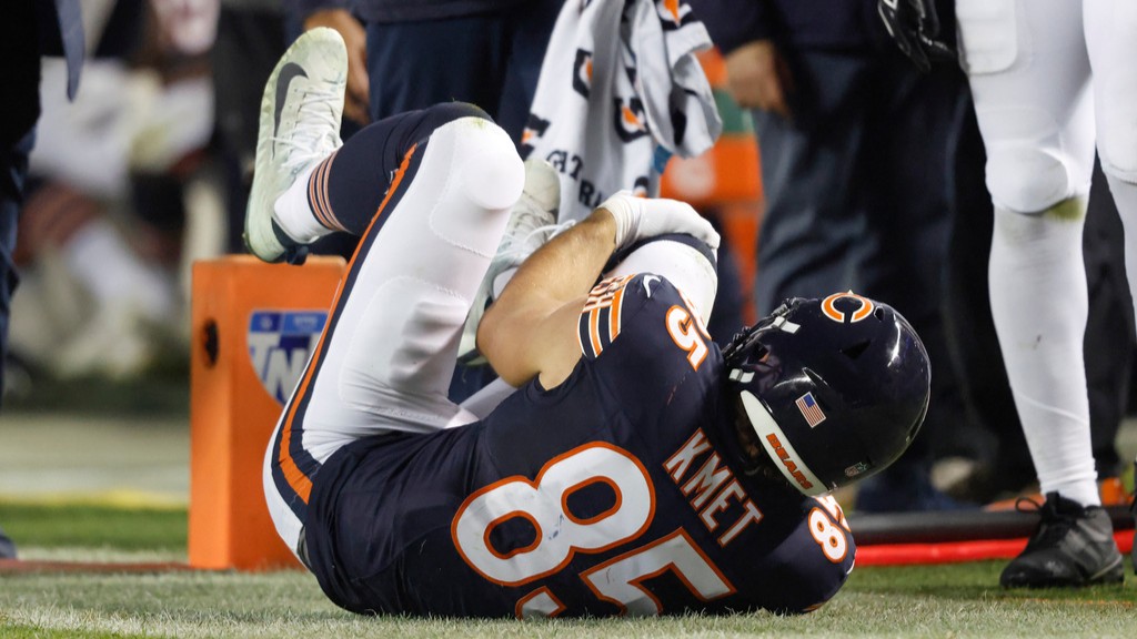 Chicago Bears tight end Cole Kmet grabs his knee after being tackled by the New England Patriots.
