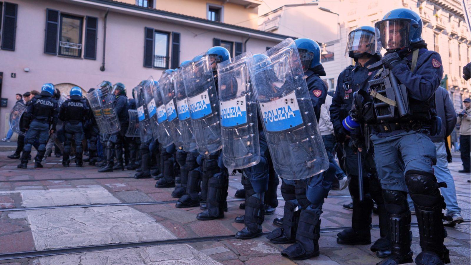 Soldiers guard center of Milan, Italy as thousands of protesters march in cities across Europe

      