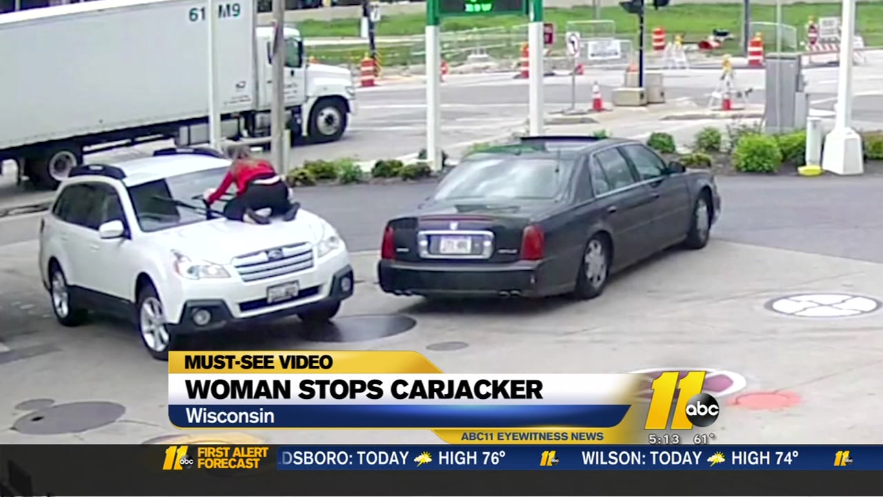 Woman stops carjacker by jumping onto hood