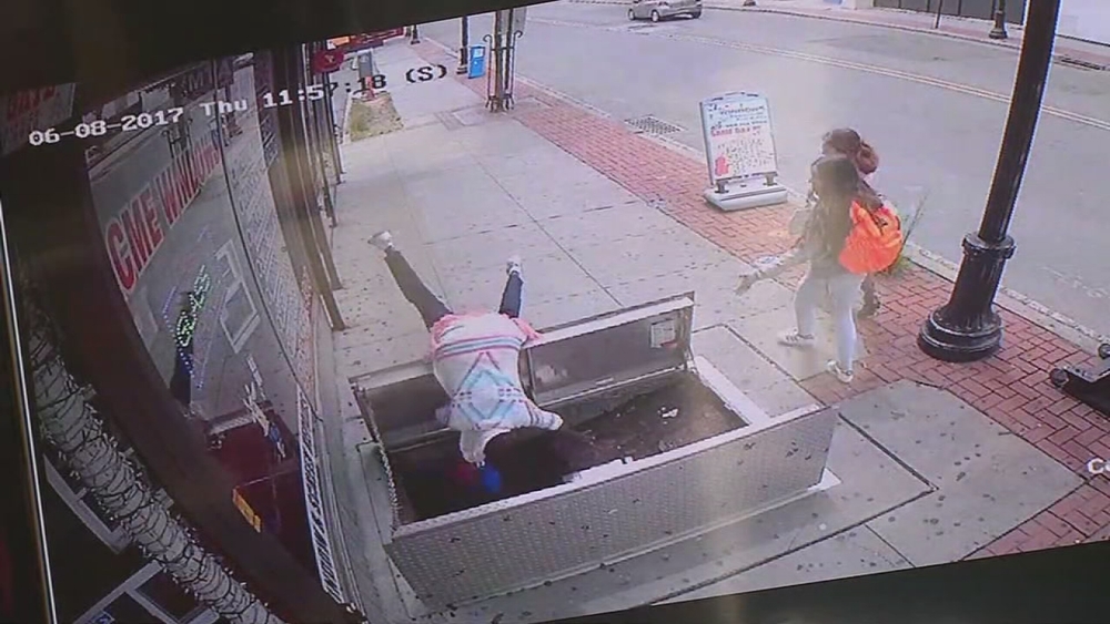Texting woman seriously hurt in fall through sidewalk access door