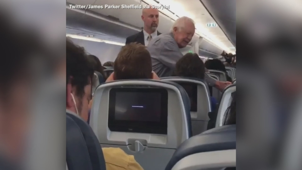 Jimmy Carter shakes hands with fellow fliers