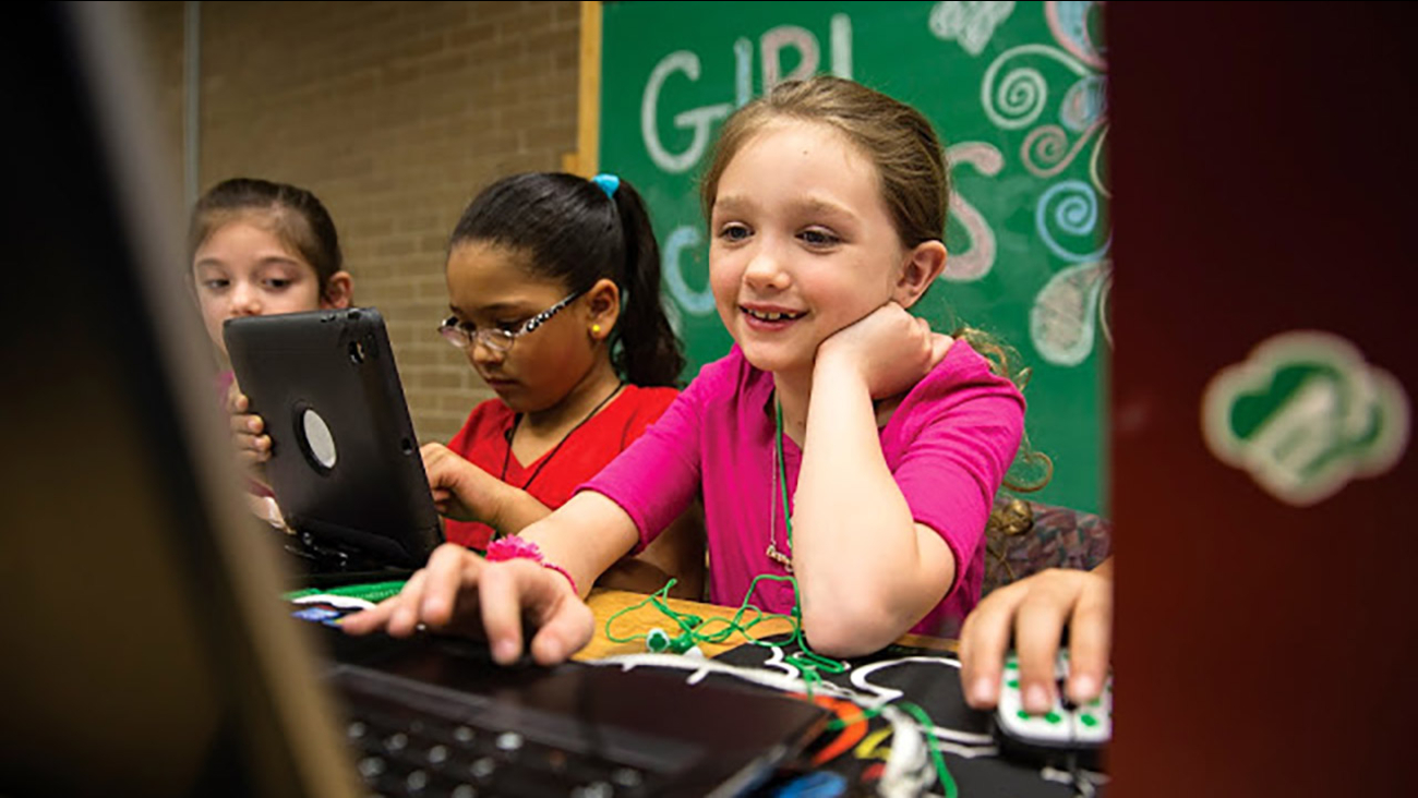 Image of a Girl Scout on a computer.