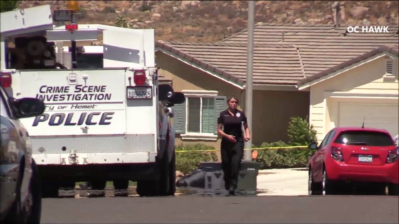 A police investigator is seen on a residential street in Hemet after two teenage boys were stabbed, allegedly by their older brother, on Monday, June 26, 2017.