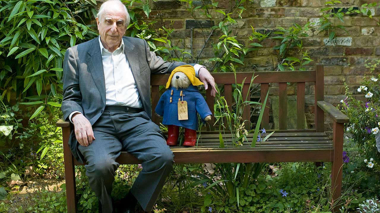 In this Thursday, June 5, 2008 file photo, British author Michael Bond sits with a Paddington Bear toy during an interview with The Associated Press in London.