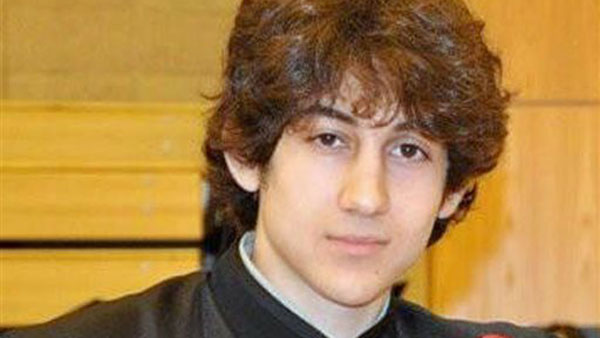 In this undated photo provided by Robin Young, Dzhokhar A. Tsarnaev, poses for a photo after graduating from Cambridge Rindge and Latin High School. Tsarnaev has been identified as the surviving suspect in the marathon bombings. Two suspects in the Boston Marathon bombing killed an MIT police officer, injured a transit officer in a firefight and threw explosive devices at police during a getaway attempt in a long night of violence that left one of them dead and another still at large Friday, April 19, 2013.