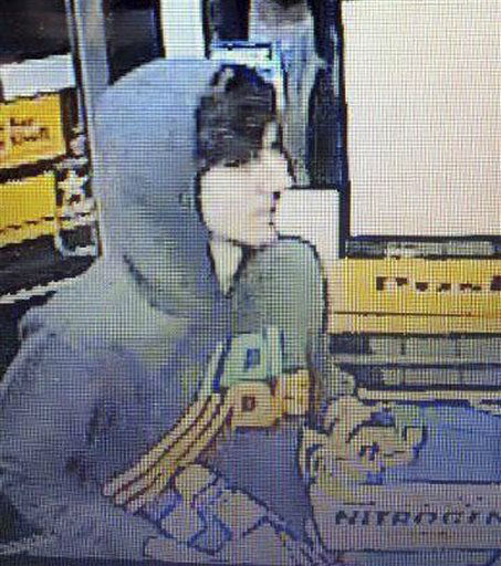 This surveillance photo released via Twitter Friday, April 19, 2013 by the Boston Police Department shows a suspect entering a convenience store that police are pursuing in Watertown, Mass. Police say he is one of two suspects in the fatal shooting of an MIT police officer and tied to the Boston Marathon bombing.