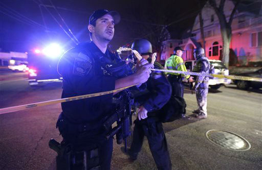 Officials secure an area in Watertown, Mass., Friday, April 19, 2013.
