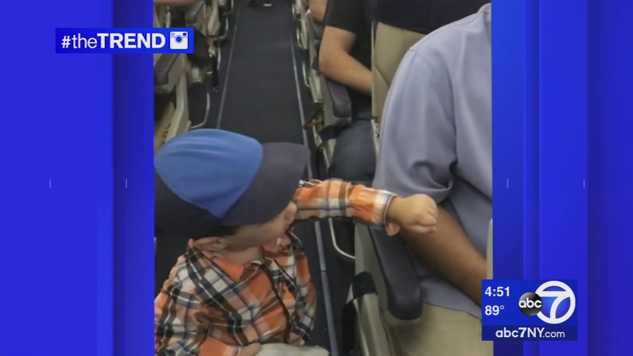 The Trend: Tiny passenger fist bumps others on a flight