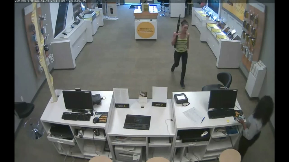 Surveillance video: Petite woman with large gun robs Fayetteville store