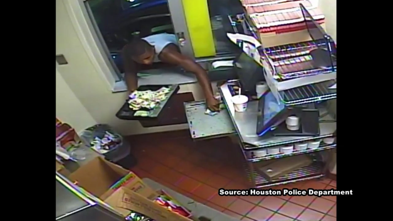Robber who forced himself through drive-thru window is on the run