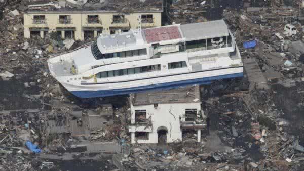 A ferry stranded on a building is seen in Otsuchi, Iwate Prefecture, northern Japan, Sunday, March 13, 2011, two days after a powerful earthquake-triggered tsunami hit the country's east coast. (AP Photo/The Yomiuri Shimbun)