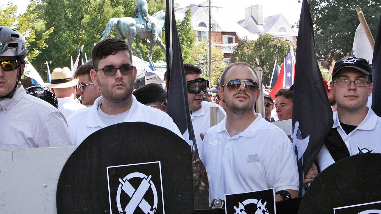 Man accused of ramming protesters pictured with racist group