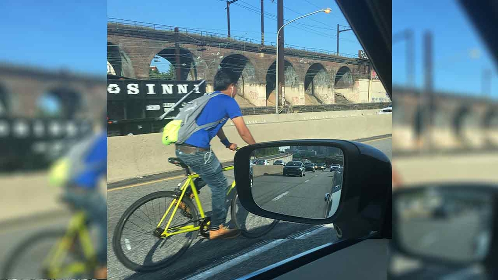 Man rides bike on I-76