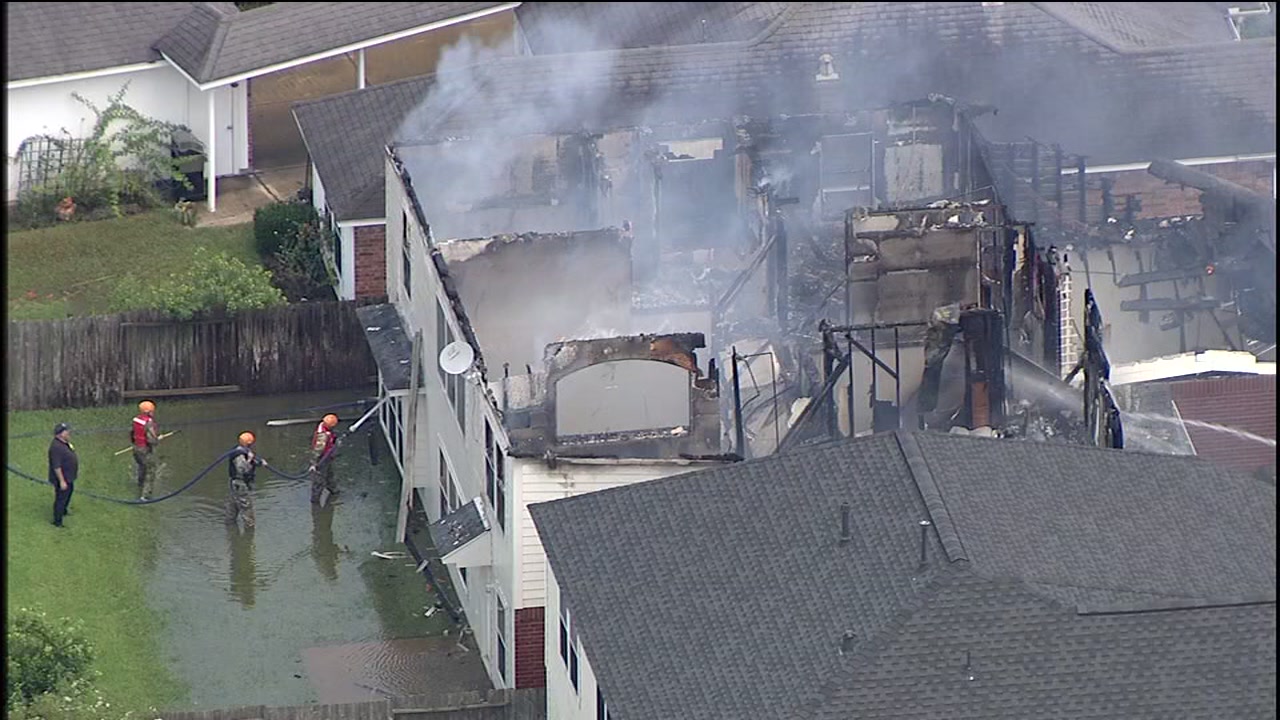 Firefighters battle fire at flooded home in Katy area