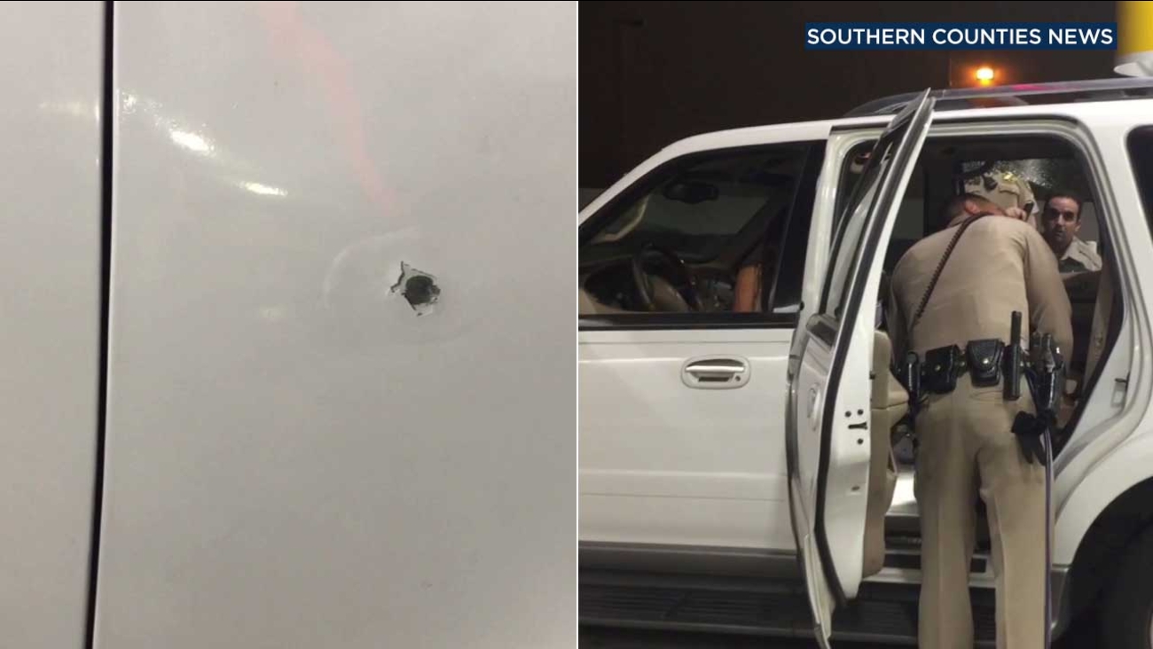 A bullet hole is seen on an SUV driven by a woman who police say was fired upon by her husband along the 91 Freeway on Friday, Sept. 1, 2017.