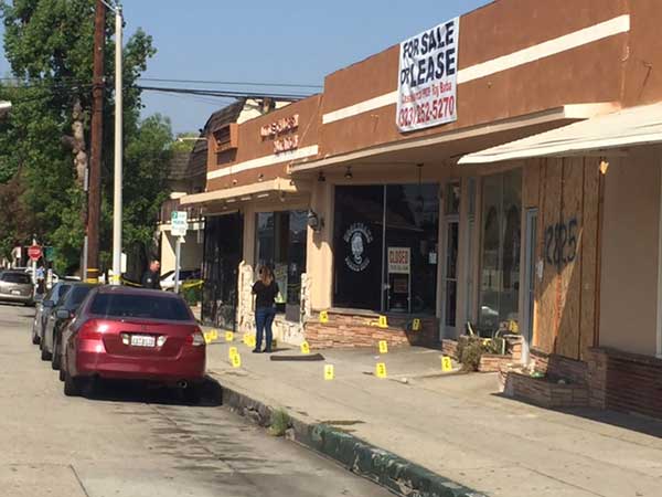 Evidence markers dot the sidewalk along Penn Street in Whittier on Friday, Sept. 8, 2017.