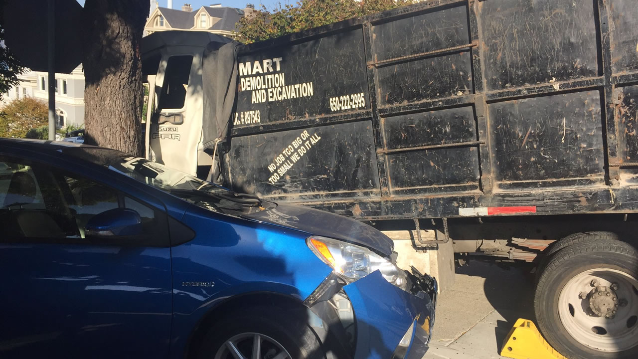 Minor injuries reported after runaway dump truck rams 9 cars in Pacific Heights