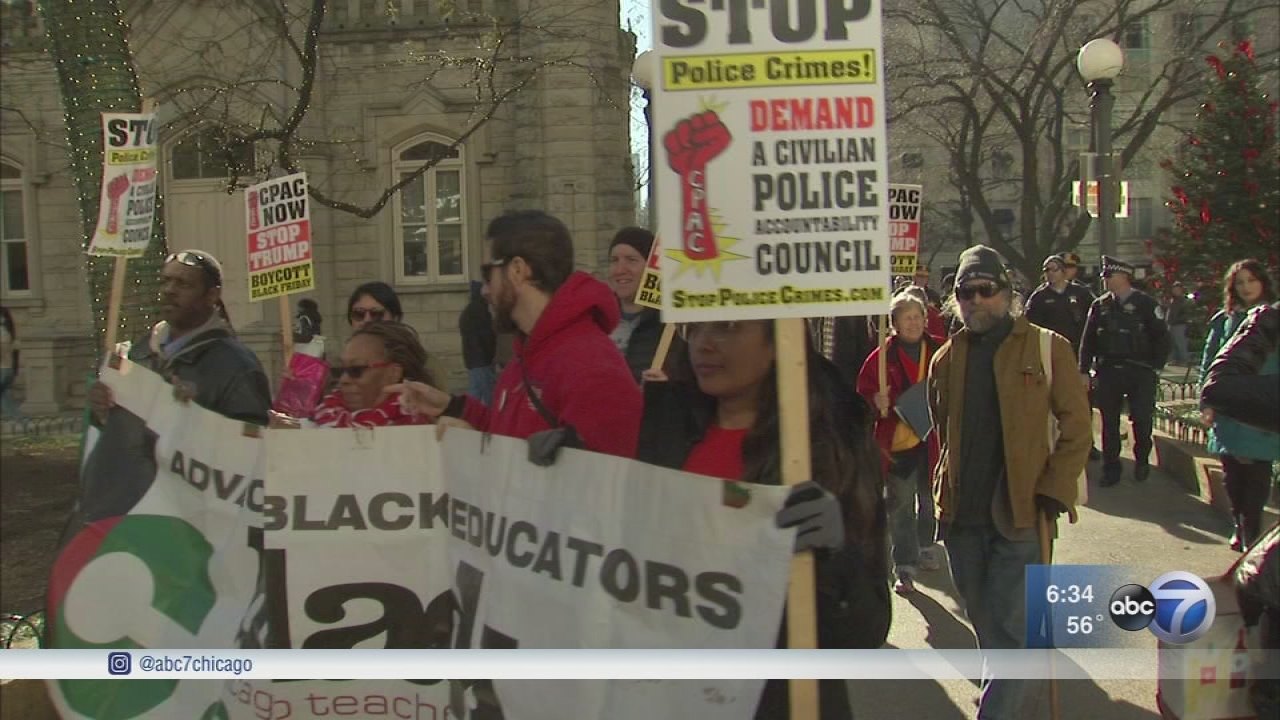 Demonstrators march on Mag Mile in Black Friday protest