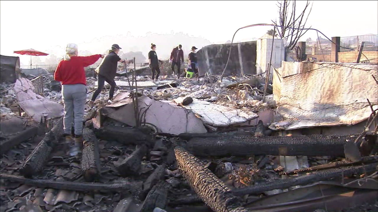 Residents sift through the rubble of a home destroyed in the Thomas Fire.