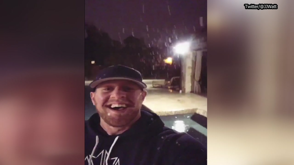 J.J. Watt takes in the snow coming down Thursday night