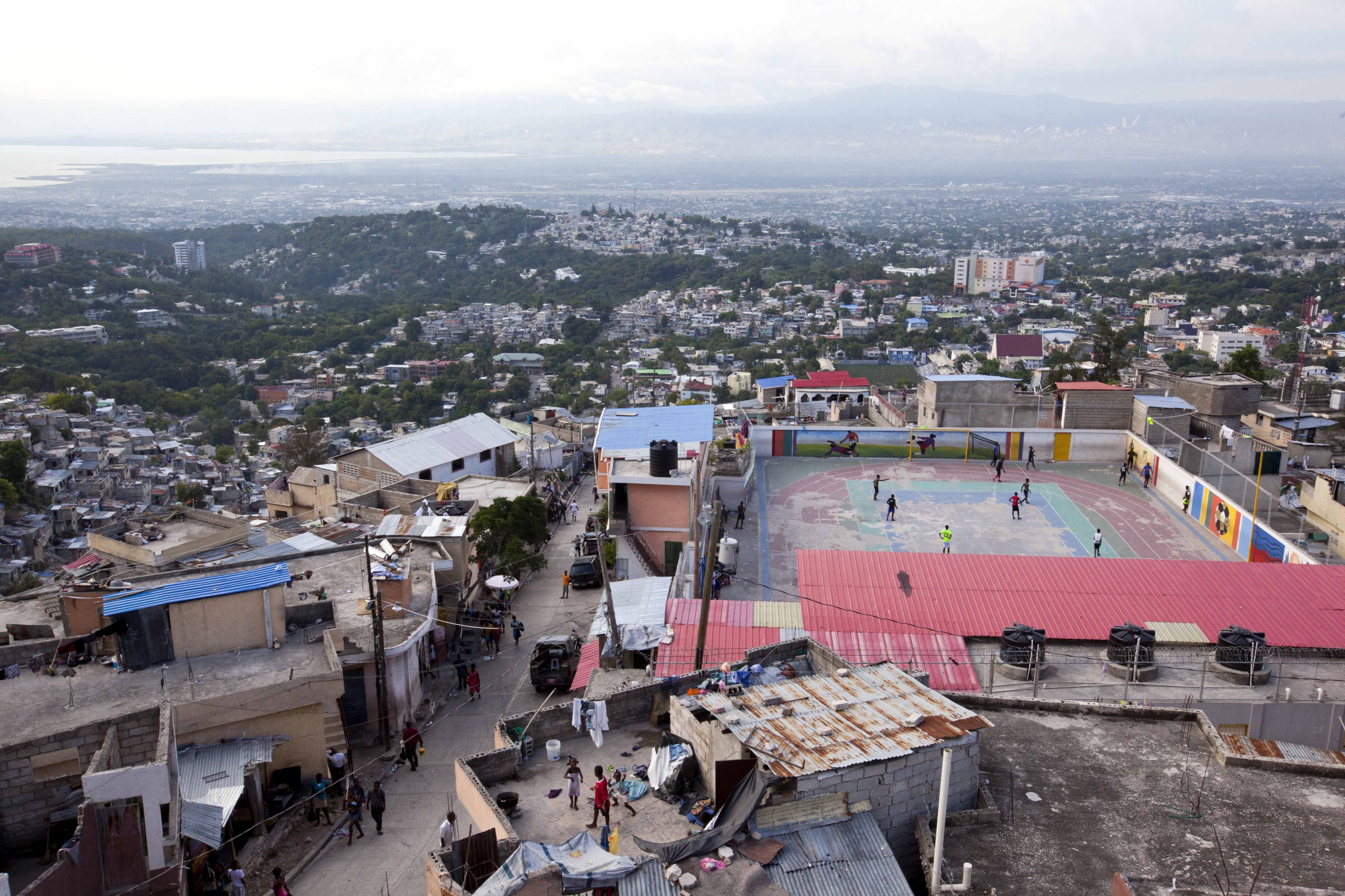 Residents play soccer on top of a hillside neighborhood in the Jalousie district of Port-au-Prince, Haiti.