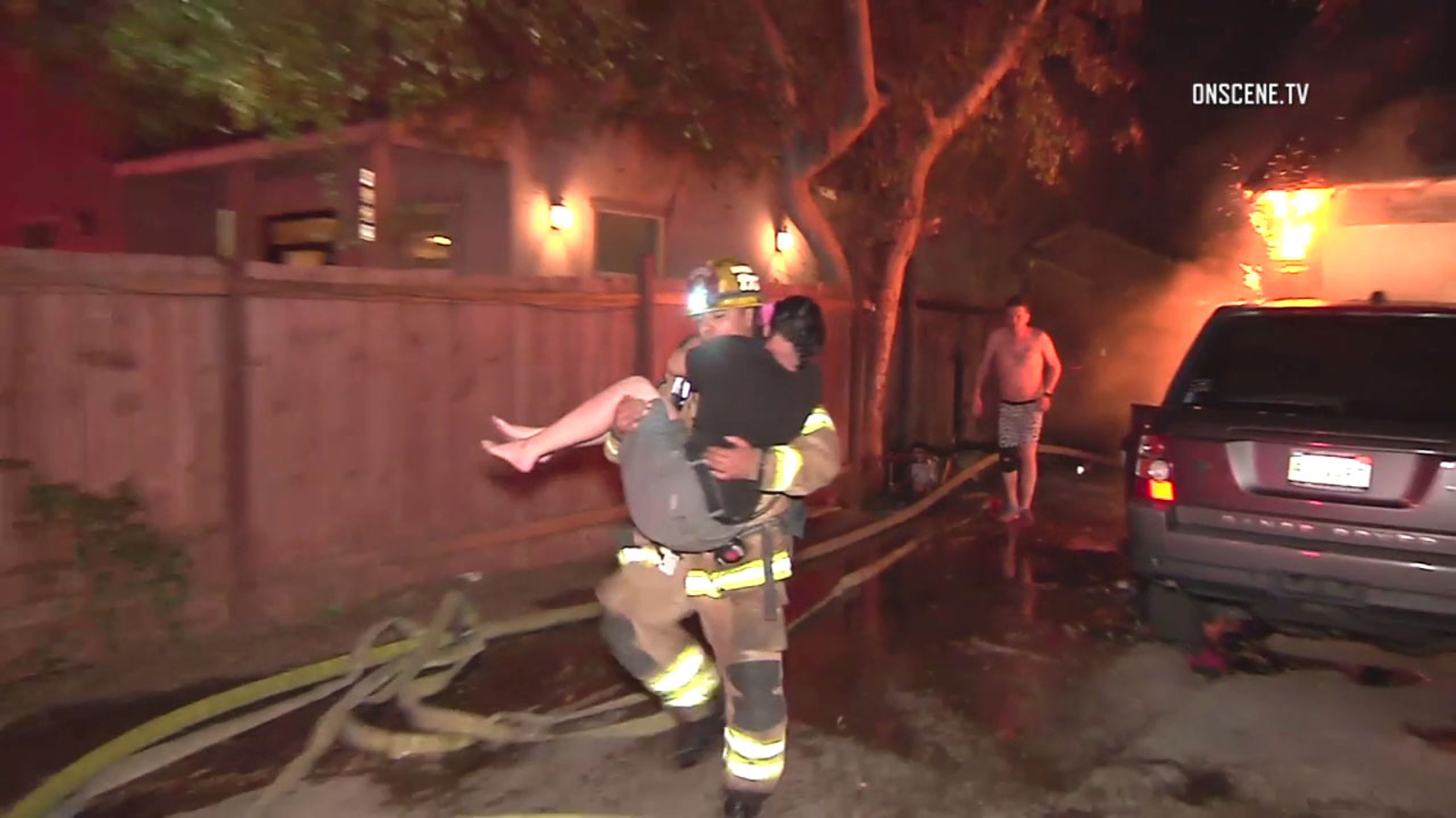 Santa Ana home destroyed in fire as firefighters carry woman to safety