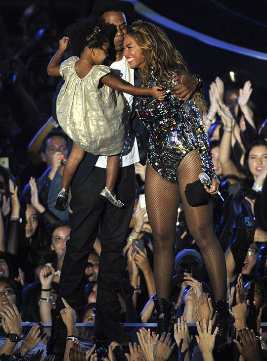 Beyonce smiles on stage with Jay Z and their daughter Blue Ivy as she accepts the Video Vanguard Award at the MTV Video Music Awards on Sunday, Aug. 24, 2014.