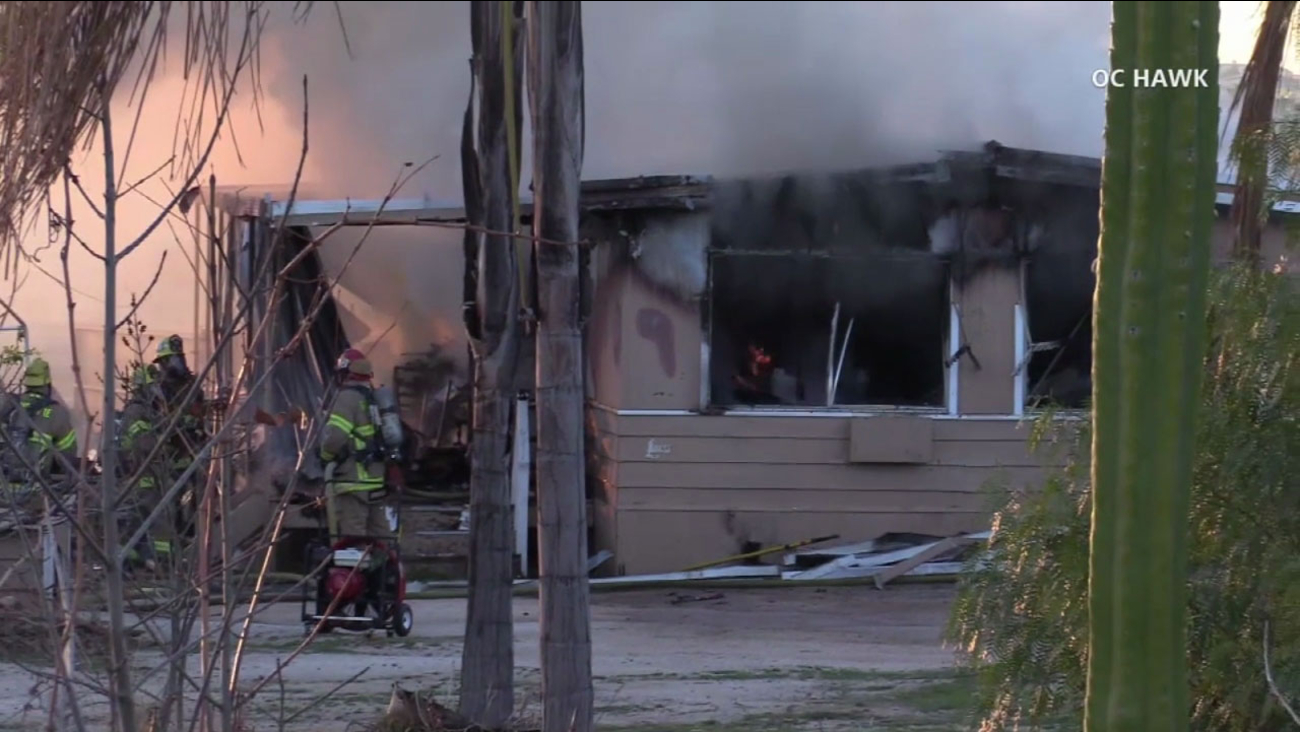 Firefighters worked to put out a fire inside a home after a man barricaded inside set it on fire in Mead Valley on Tuesday, Jan. 23, 2018.