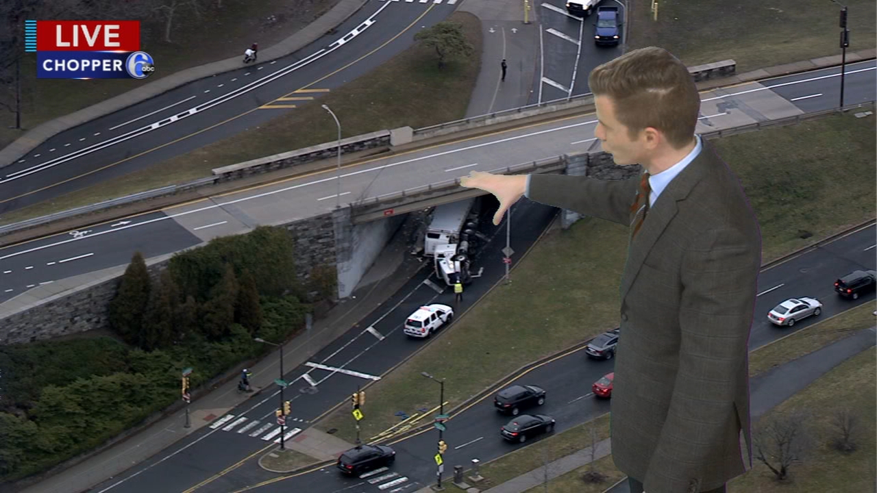 Tractor-trailer lands on its side on ramp along MLK Drive