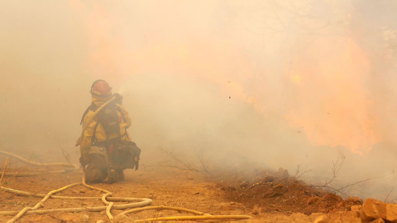 A firefighter is shrouded in smoke as he battles the King fire near Fresh Pond Fresh Pond, Calif., Wednesday, Sept. 17, 2014.
