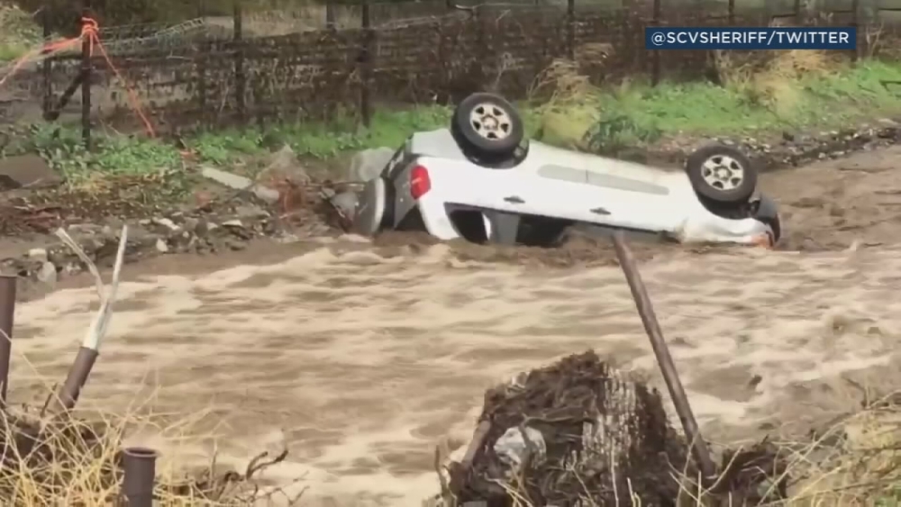 VIDEO: Car swept up in floodwaters in Santa Clarita