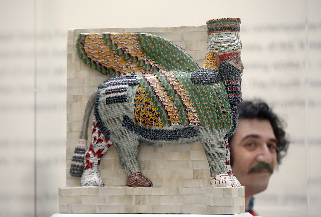 Artist Michael Rakowitz poses at the National Gallery in London on March 21, 2017 next to his winning design entitled "The Invisible Enemy Should Not Exist."