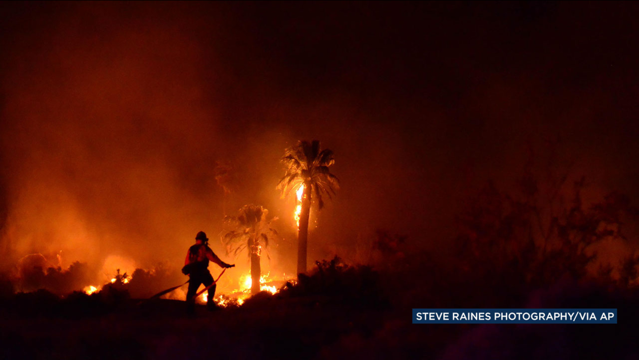 A firefighter battles a blaze at Joshua Tree National Park on Monday, March 26, 2018.