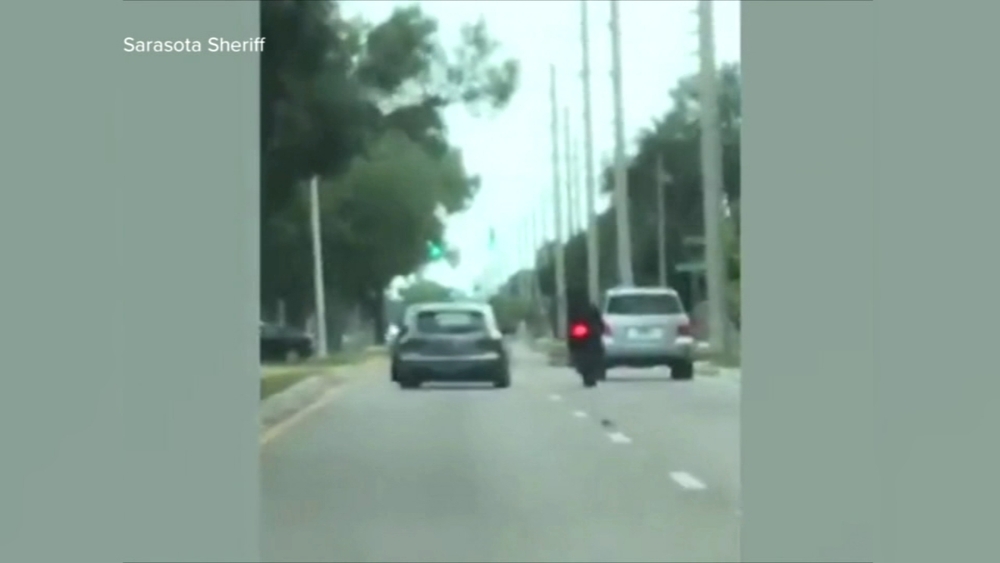 Car rams motorcyclist in suspected road rage incident