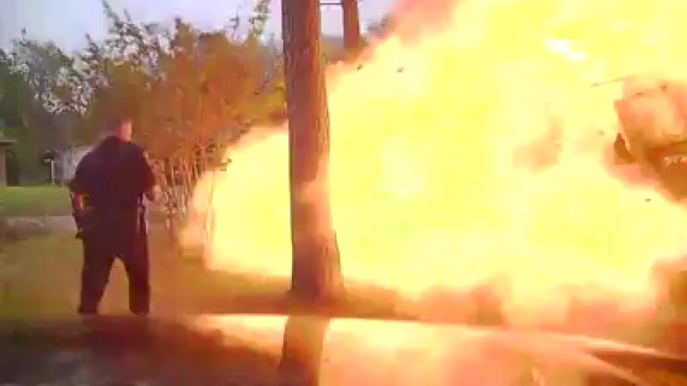 Dash-cam video of house exploding just as an officer makes the scene
