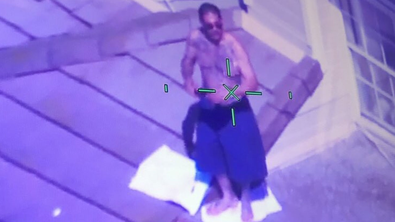 Shirtless man armed with a gun barricaded himself on roof of a home in ...