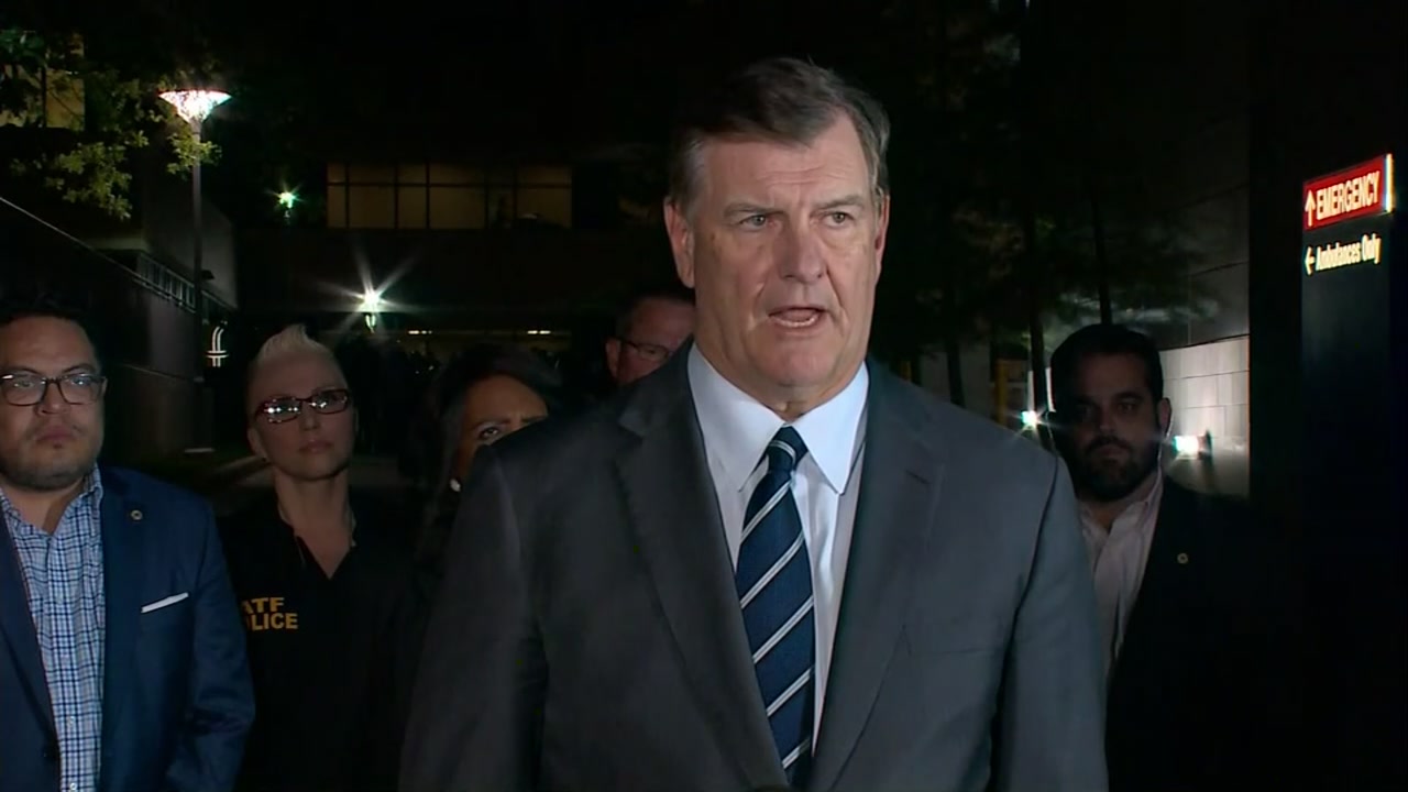 The mayor of Dallas and police chief brief the media outside hospital where officers are being treated