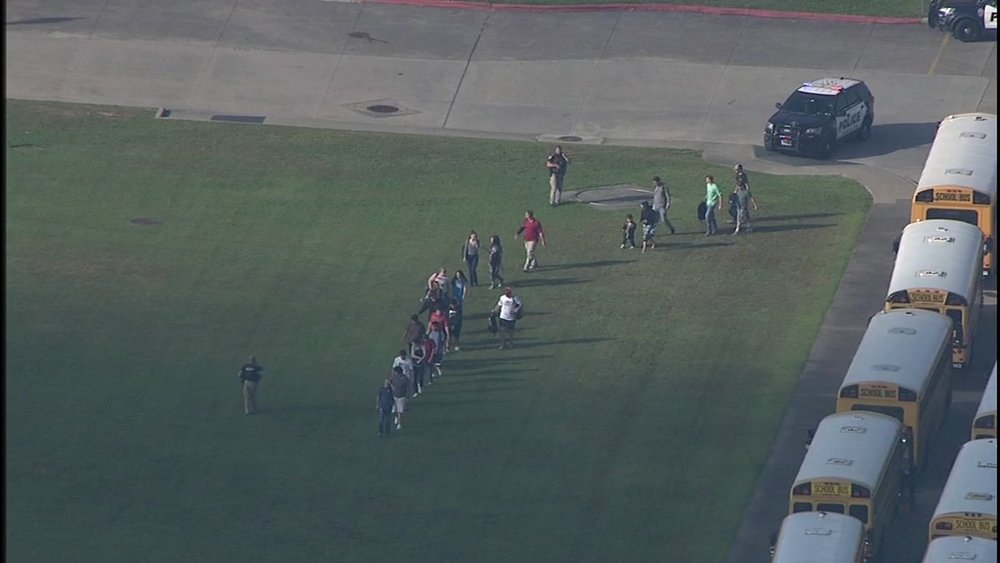 Santa Fe High School students being escorted out by officers after active shooter incident 