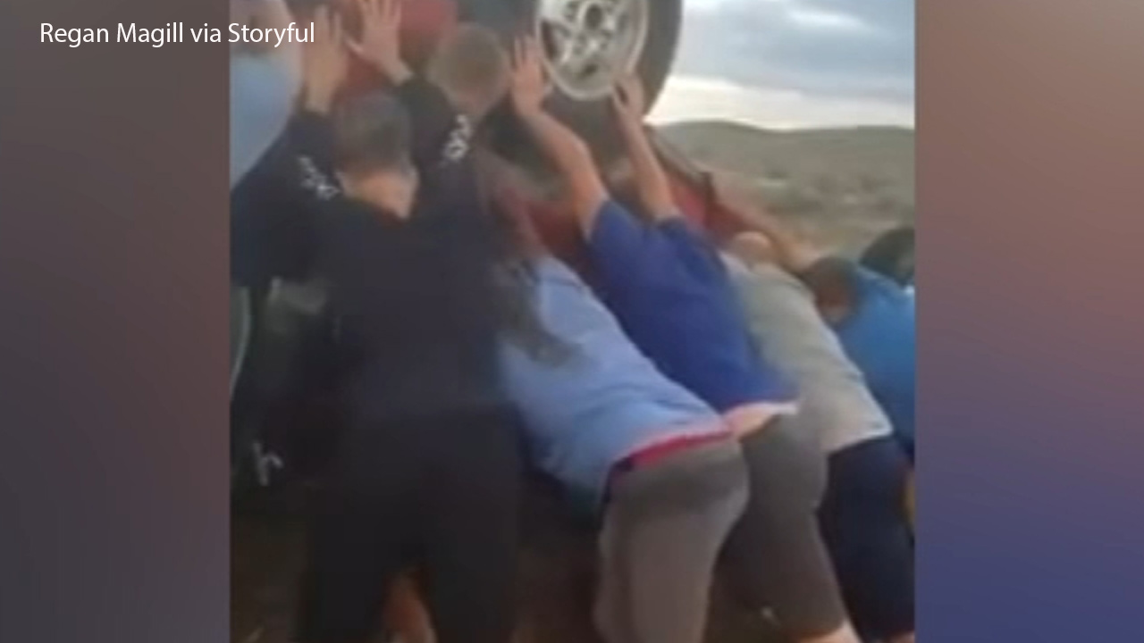 VIDEO: Youth football team rescues pair from car crash