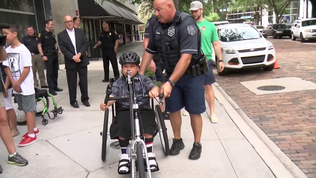 Police gift bike to little boy with walking disability