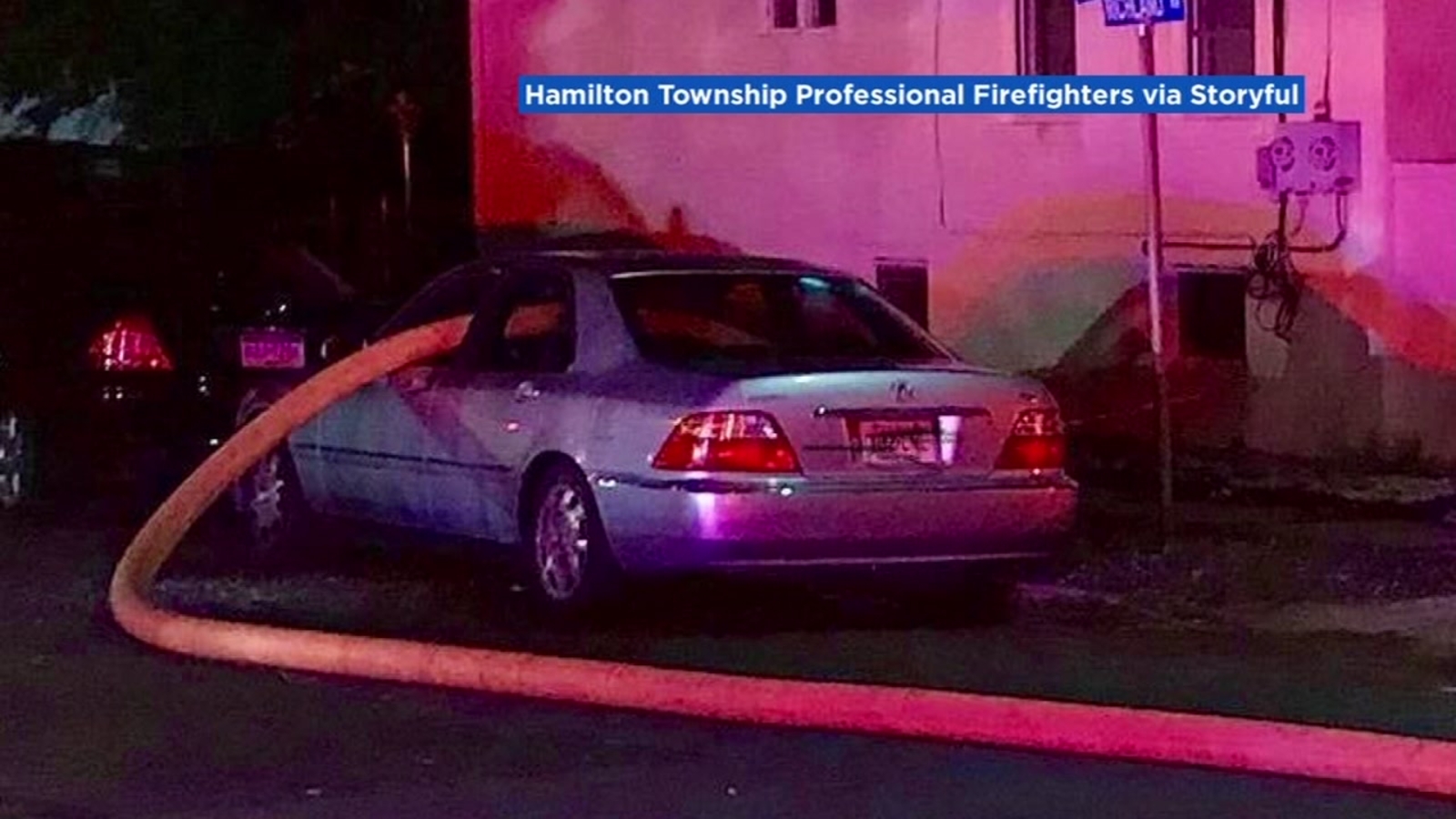 Firefighters break windows, run hose through car parked in front of